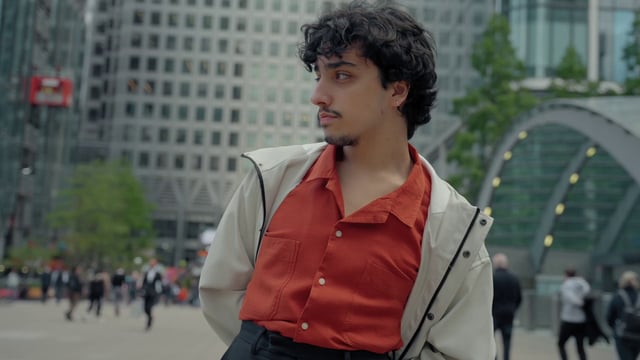 A young man posing on the street in the city