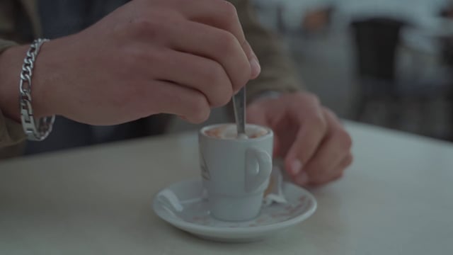 A guy stirring coffee