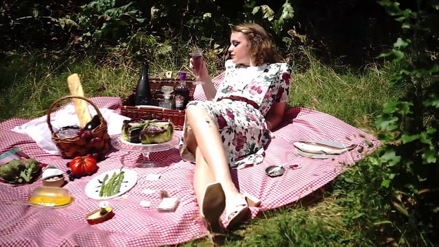 Woman having a drink at a picnic