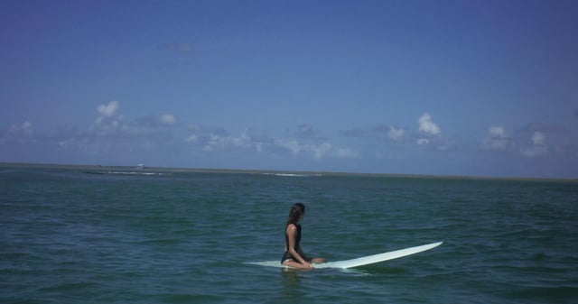A female surfer waiting for a wave