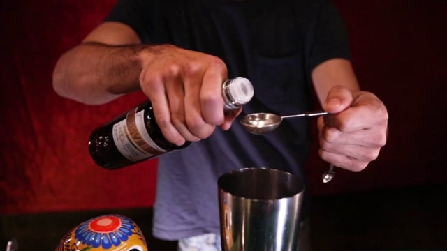 Pouring agave syrup into cocktail shaker
