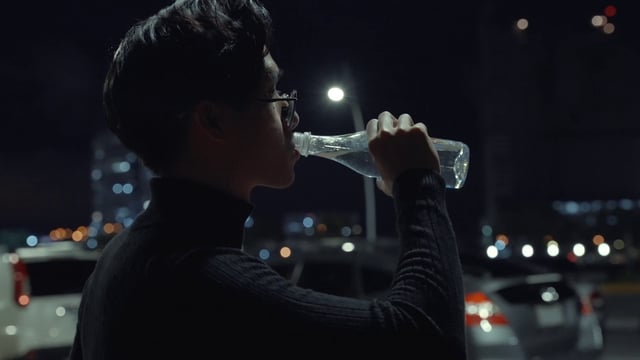 Hombre asiático bebe agua