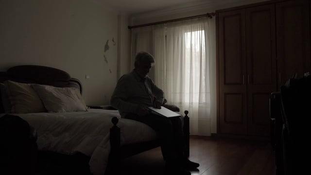 Old man opening up a laptop