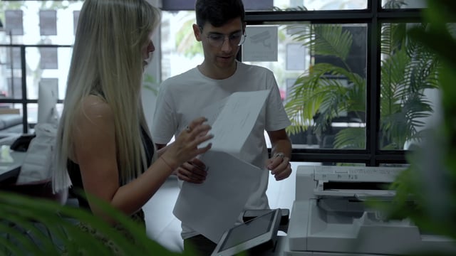 Workers make copies of documents on the printer