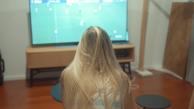 A girl watching a football match