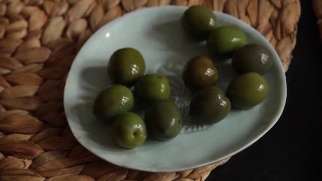 Hands picking up olives
