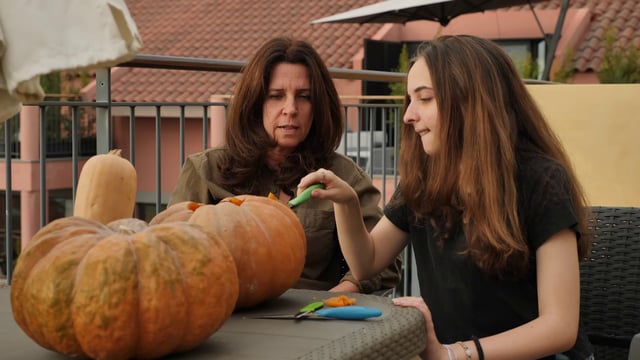 Carving a pumpkin outdoors