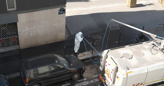 Cleaning a street in Paris, France