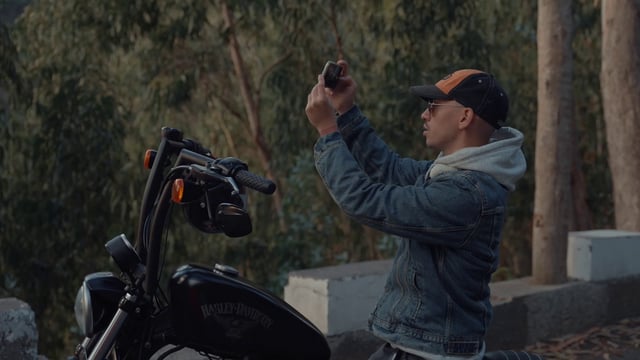 A motorcyclist taking photos of the landscape