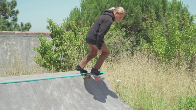 A skateboarder failing at a skateboarding trick on a ramp