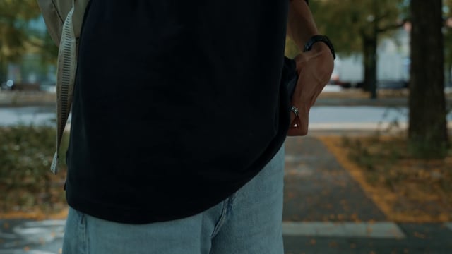 A man puts his smartphone into his pocket