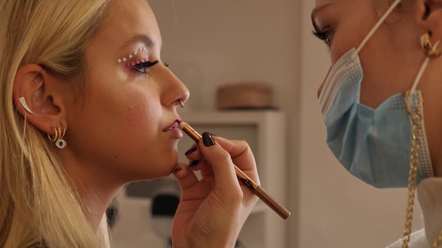 Makeup artist uses a lip pencil