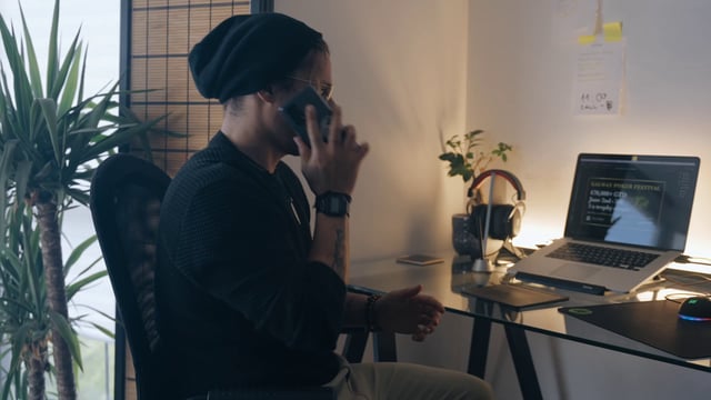 A man makes a phone call at his home office
