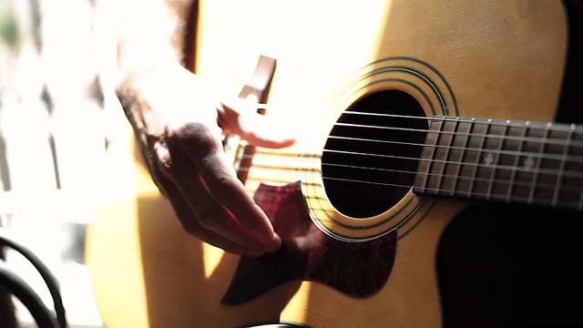 Hands playing the guitar