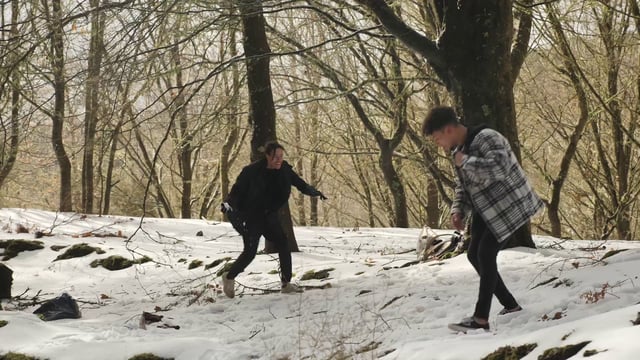 Friends throwing snow at each other