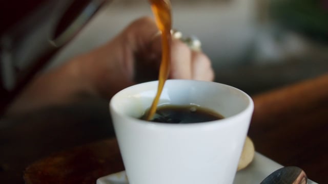 Pouring coffee in a mug