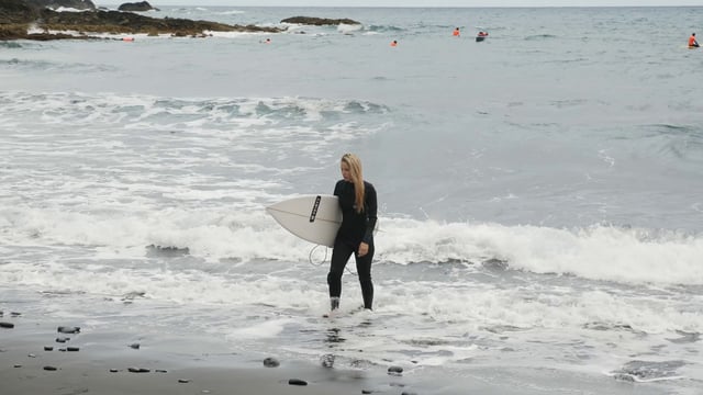 Woman holding a surfboard