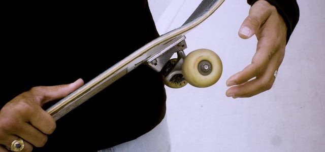 Man rolling his skateboard wheel