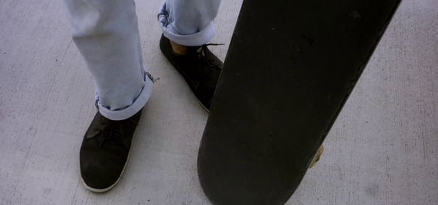 Man twisting his skateboard on the asphalt