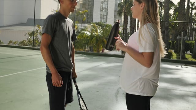 Man and woman talking after a tennis match