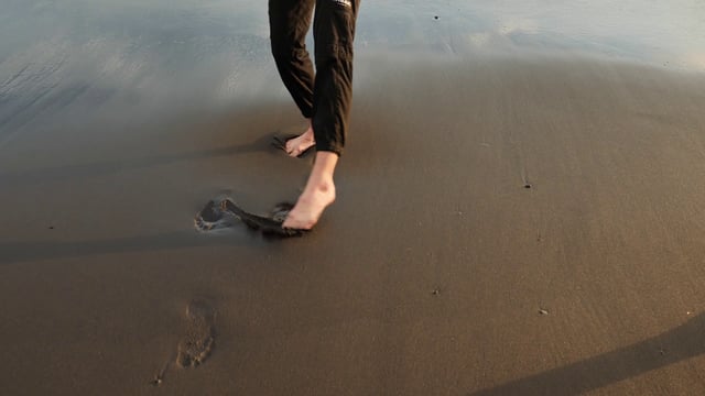 Moving feet in the wet sand