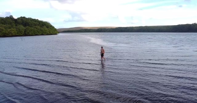 Man walking in shallow water at the sea