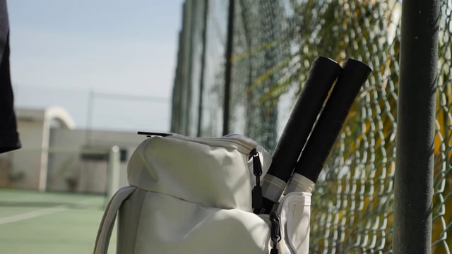 Taking tennis rackets out of a bag