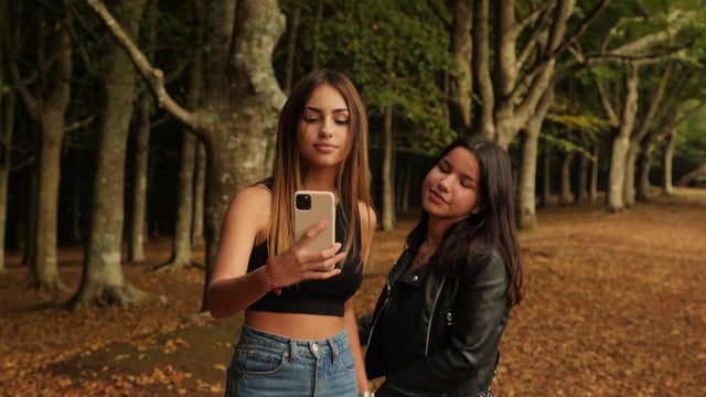 Girls taking a selfie in the forest