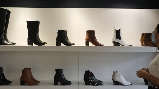 Woman looking at boots - Free Stock Video Footage | Coverr