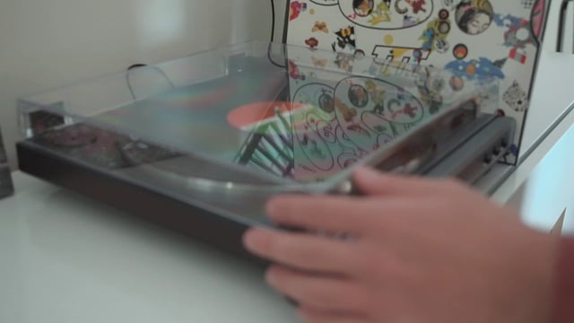 A guy opening a turntable