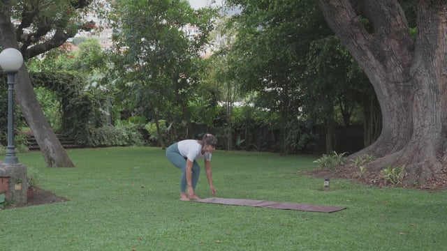 Yoga teacher rolling a yoga mat up
