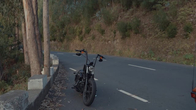 A motorcyclist approaching his bike and starting it