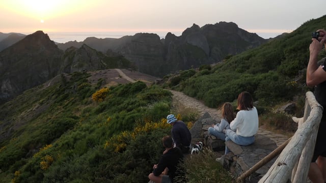Friends watching the sunset on mountain top