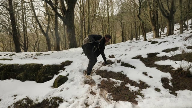 Man goes down a snowy hill