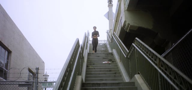 Woman running down outdoor steps