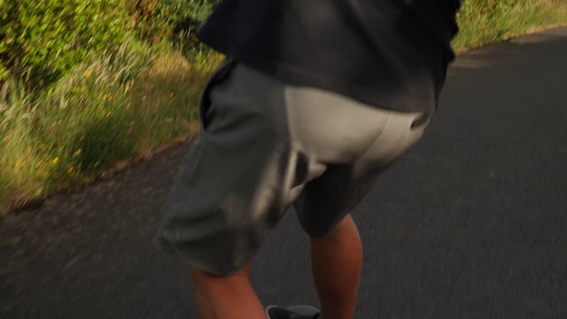 Man skateboarding down the road 