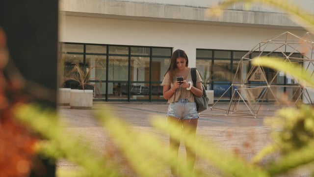 Girl texting on school campus