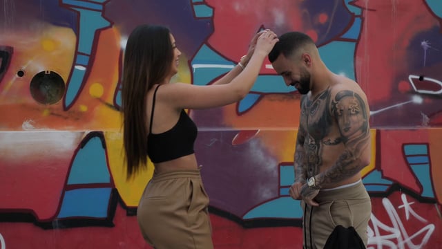 Woman adjusts her boyfriend's hair
