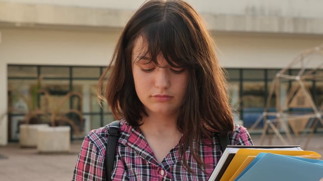 College student texting on school campus