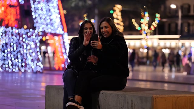 Women video calling outdoors