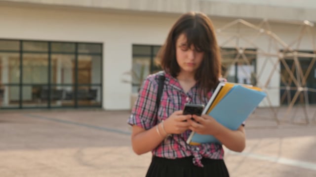 Girl texting on the school campus