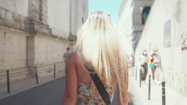 Girl walking down an old city street