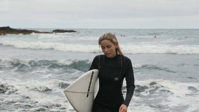 Surfer girl near the ocean 