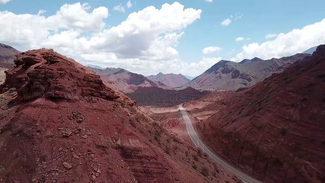 Road between red rocks in Salta, Argentina