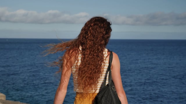 Woman walking near the ocean
