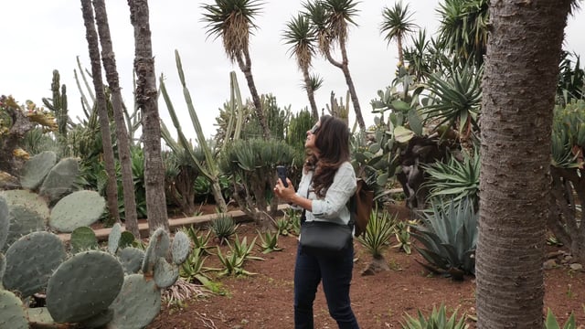 Woman takes photos in a botanical garden