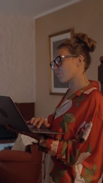 A girl searching on the NFT marketplace using her smartphone and laptop
