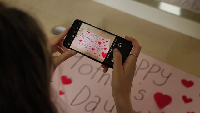 Taking photos of a Mother's Day poster with a smartphone