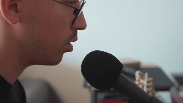 A guy singing into a microphone
