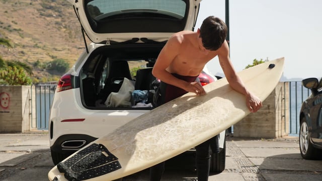 Rubbing wax on surfboard